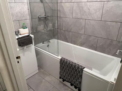 a bathroom with a shower and a bath tub at Dads 2 in Balby