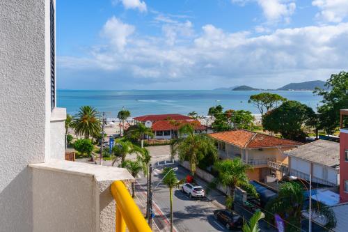 a view of the ocean from the balcony of a building at Boulevard Beach Canasvieiras Hotel in Florianópolis