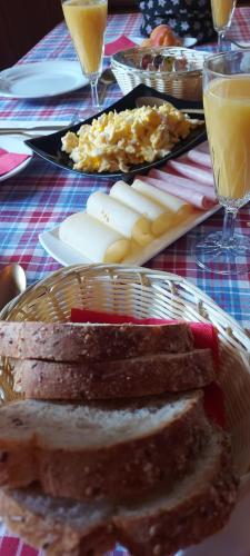 a table with a plate of food with bread and cheese at LES TOURISTES in Le Chatelard