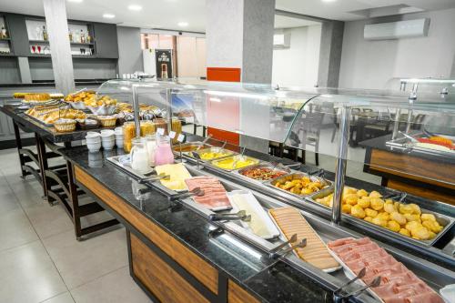 a buffet line with many different types of food at Boulevard Beach Canasvieiras Hotel in Florianópolis