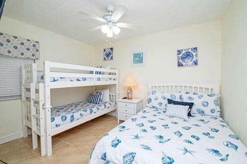 a bedroom with two bunk beds and a ceiling fan at 3203 Near Ocean 2nd Floor NW in Saint Augustine Beach