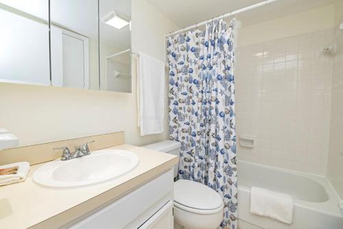 a bathroom with a sink and a toilet and a shower at 3203 Near Ocean 2nd Floor NW in Saint Augustine Beach