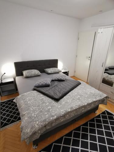 a bed with two pillows on it in a room at Apartman Perry Bijeljina in Bijeljina