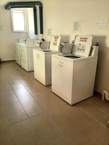 a row of white appliances sitting in a room at Departamento con vista al mar en Puerto Montt in Puerto Montt
