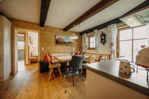 a kitchen and dining room with a table and chairs at Bauernhof Unterbichl in Flachau