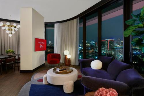 a living room with a purple couch and a table at Virgin Hotels Dallas in Dallas