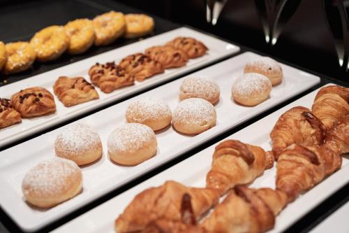 a bunch of pastries on trays in a bakery at Stella Hotel - My Dolomites Experience in Selva di Val Gardena
