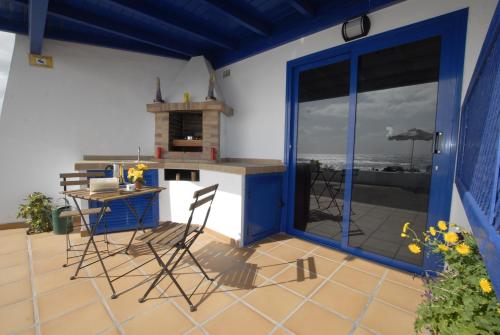 a kitchen with a table and chairs on a patio at Punta mujeres casitas del mar in Arrieta