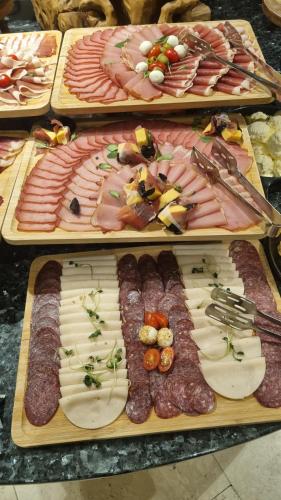 a display of different types of meats and appetizers at Kraljevi Konaci Olja in Zlatibor