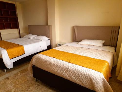 Llit o llits en una habitació de CASA HOTEL GUADALUPE