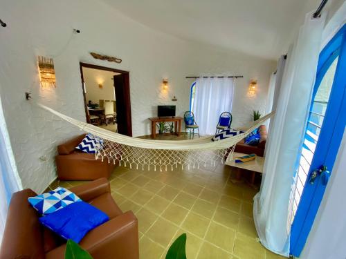 a living room with a hammock in a room at Casa com Spa Praia do Pernambuco in Guarujá