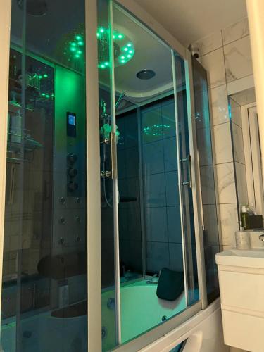 a bathroom with a glass shower with a tub at The Elegance in Chatteris