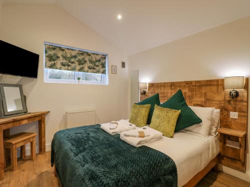 a bedroom with a bed with towels on it at Bluebell in Swadlincote