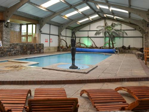 a swimming pool with a statue in a building at Croyde - Ukc3785 in West Down