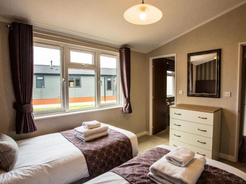 a bedroom with two beds and a large window at Silver Birch - Ukc4529 in Darsham