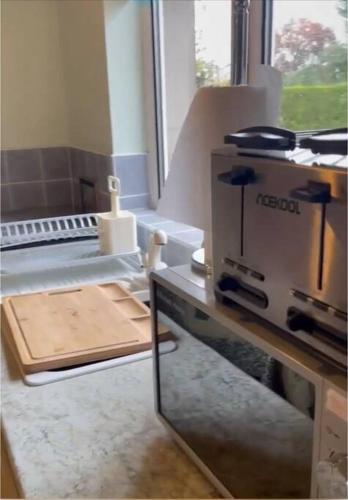 a kitchen with a counter with a cutting board at Annie Dee’s Guest Accommodation in Ballygowan