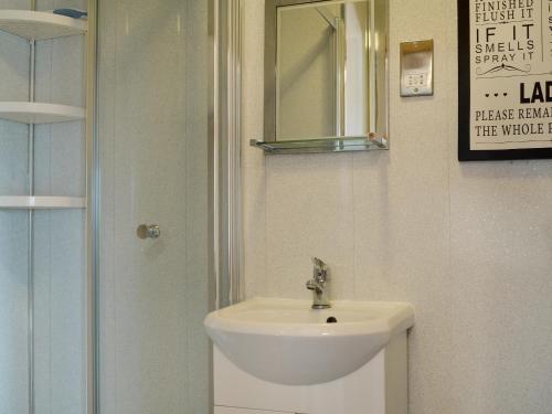 a bathroom with a sink and a mirror at Pheasant Cottage - Ukc3428 in Dalston