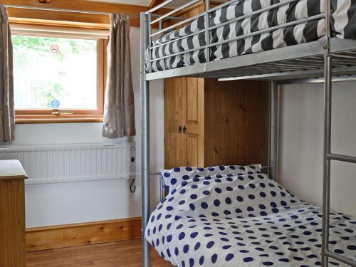 a bunk bed in a room with a bunk beduteneway at Pheasant Cottage - Ukc3428 in Dalston