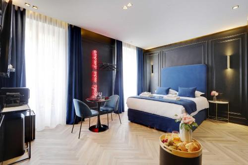 a bedroom with a bed and a table with a bowl of fruit at Couples Getaway Unit with Jacuzzi - City Center in Paris