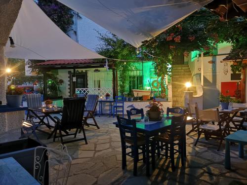 an outdoor patio with tables and chairs and lights at Haus Niko Apartments and Suites in Nea Potidaea