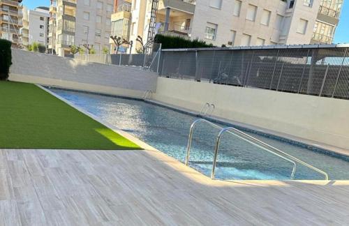 a swimming pool with a hand rail in a building at Hogar en Benicasim in Benicàssim