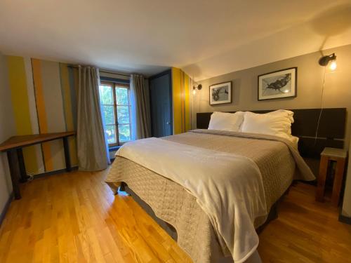 a bedroom with a large bed and a window at L'enchantement Vacation home by Rendez-Vous Mont-Tremblant in Mont-Tremblant
