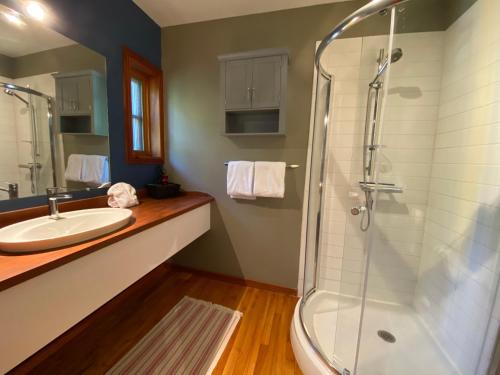 a bathroom with a sink and a shower at L'enchantement Vacation home by Rendez-Vous Mont-Tremblant in Mont-Tremblant