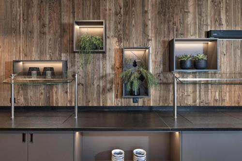 a room with a counter with potted plants on it at Alpenhotel Wurzer in Filzmoos