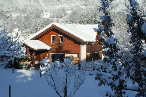 a log cabin with snow on the roof at Chambre d'hôtes "LES CRETS" in Mercury
