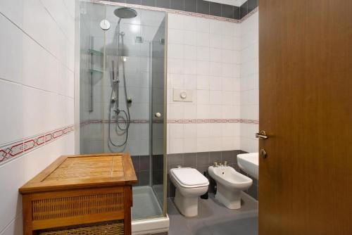 a bathroom with a shower and a toilet and a sink at Villa La palmetta in Peschiera Borromeo