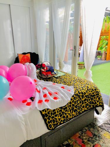 a bedroom with a bed with balloons on it at MeeZee Pearl Double Bed Lodge With Free Parking in Manchester