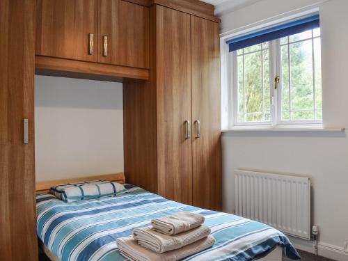 a bedroom with a bed with towels on it at Carlton House in Hazel Grove