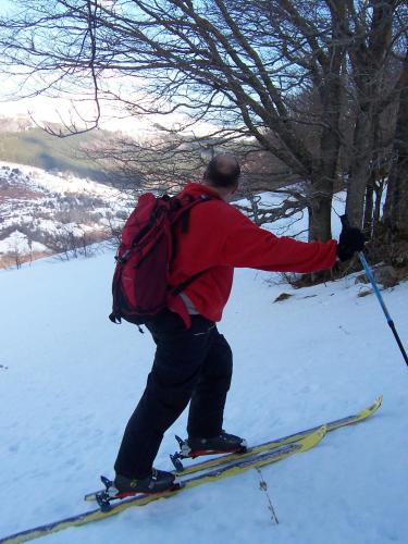 a man with a backpack on skis in the snow at Auberge Hôtel de Tournemire - Cantal in Tournemire
