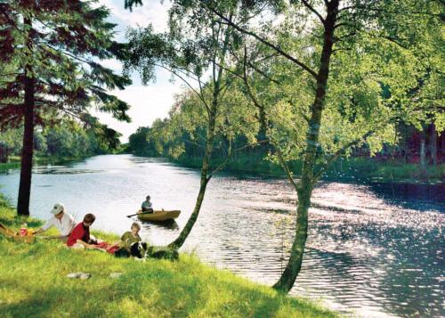 a group of people sitting on the grass next to a river at Delny Highland Lodges in Invergordon