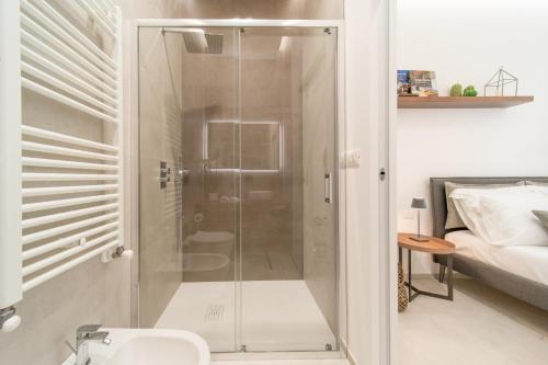 a bathroom with a shower with a glass door at Daline Holiday Rooms in Acquarica del Capo