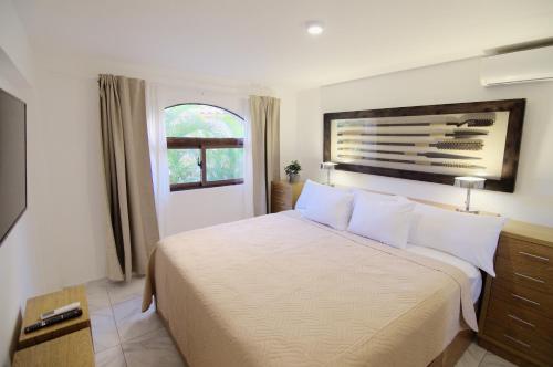 a bedroom with a large white bed with a window at Resort Atlantic Villas & Spa in Punta Cana