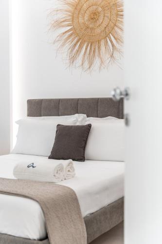 a bedroom with a bed with a chandelier above it at Daline Holiday Rooms in Acquarica del Capo