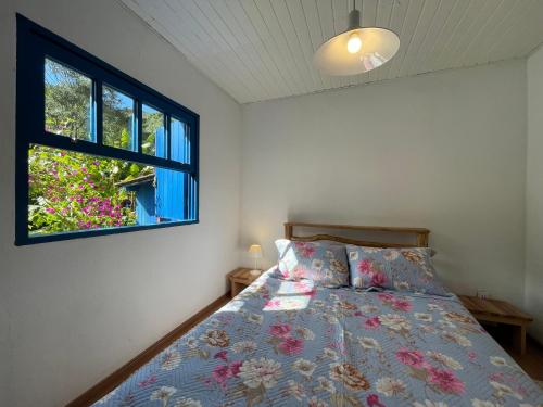 a bedroom with a bed and a window at Hospedaria Fazenda São João do Vale da Grama in Visconde De Maua