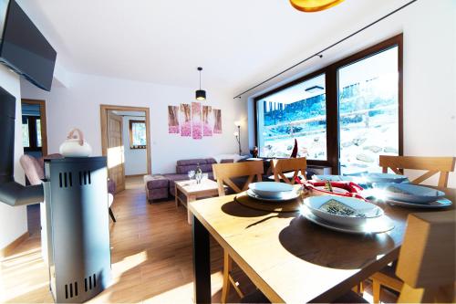 a living room with a table and a dining room at Villa pod hviezdami Jasná in Demanovska Dolina