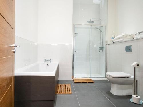 a bathroom with a shower and a sink and a toilet at Strathspey Lodge in Duthil