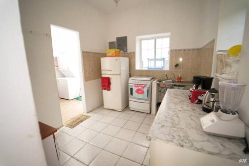 a kitchen with two refrigerators and a counter top at Casa con PISCINA PRIVADA a 4 min del IRTRA REU in Ajaxá