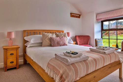 a bedroom with a bed with two towels on it at Finest Retreats - Harp House in Dolwyddelan