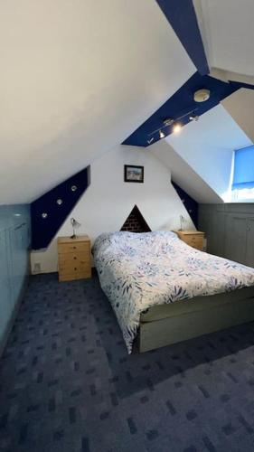 a attic bedroom with a bed and a window at Palaz 6 - 2 bedroom flat in Edmonton