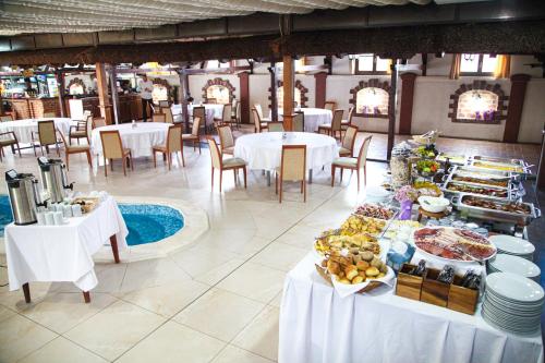 a table with food on it in a restaurant at S Club Resort Hotel Aqua Park and Spa in Belgrade