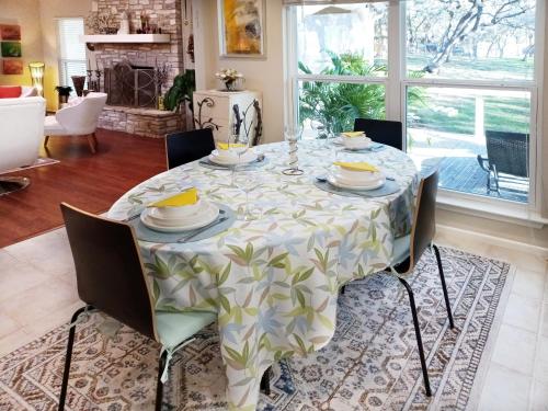 a dining room table with chairs and a tablecloth on it at King Bed in Relaxing Oasis, with FREE Snack/Wi-Fi/Parking in San Marcos
