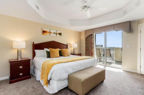 a bedroom with a large bed and a balcony at Ocean View 3 Bedroom Unit #1607 Royale Palms condo in Myrtle Beach
