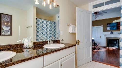 a bathroom with two sinks and a fireplace at The Jepson Estate on Forsyth Park! in Savannah