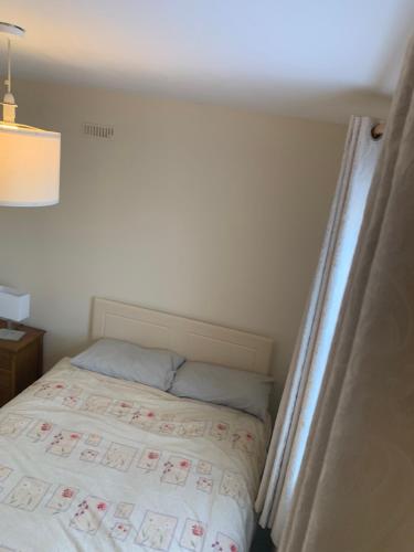 a small bed in a room with a white bedspread at One Bedroom Apartment Dublin in Dublin