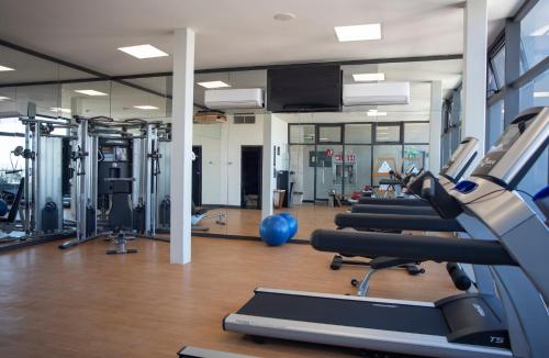 a gym with a bunch of treadmills and machines at voco Guadalajara Neruda by IHG in Guadalajara