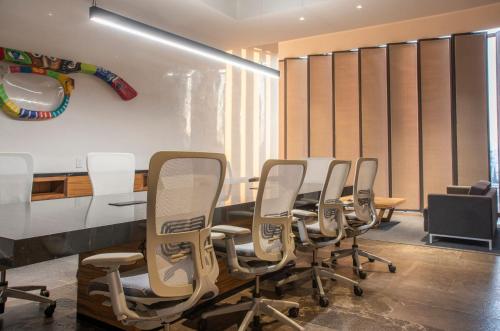 a conference room with a table and chairs at voco Guadalajara Neruda by IHG in Guadalajara